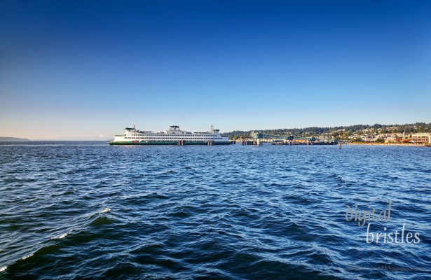 Washington State ferry arrives at the Edmonds dock late on a sunny Summer afternoon