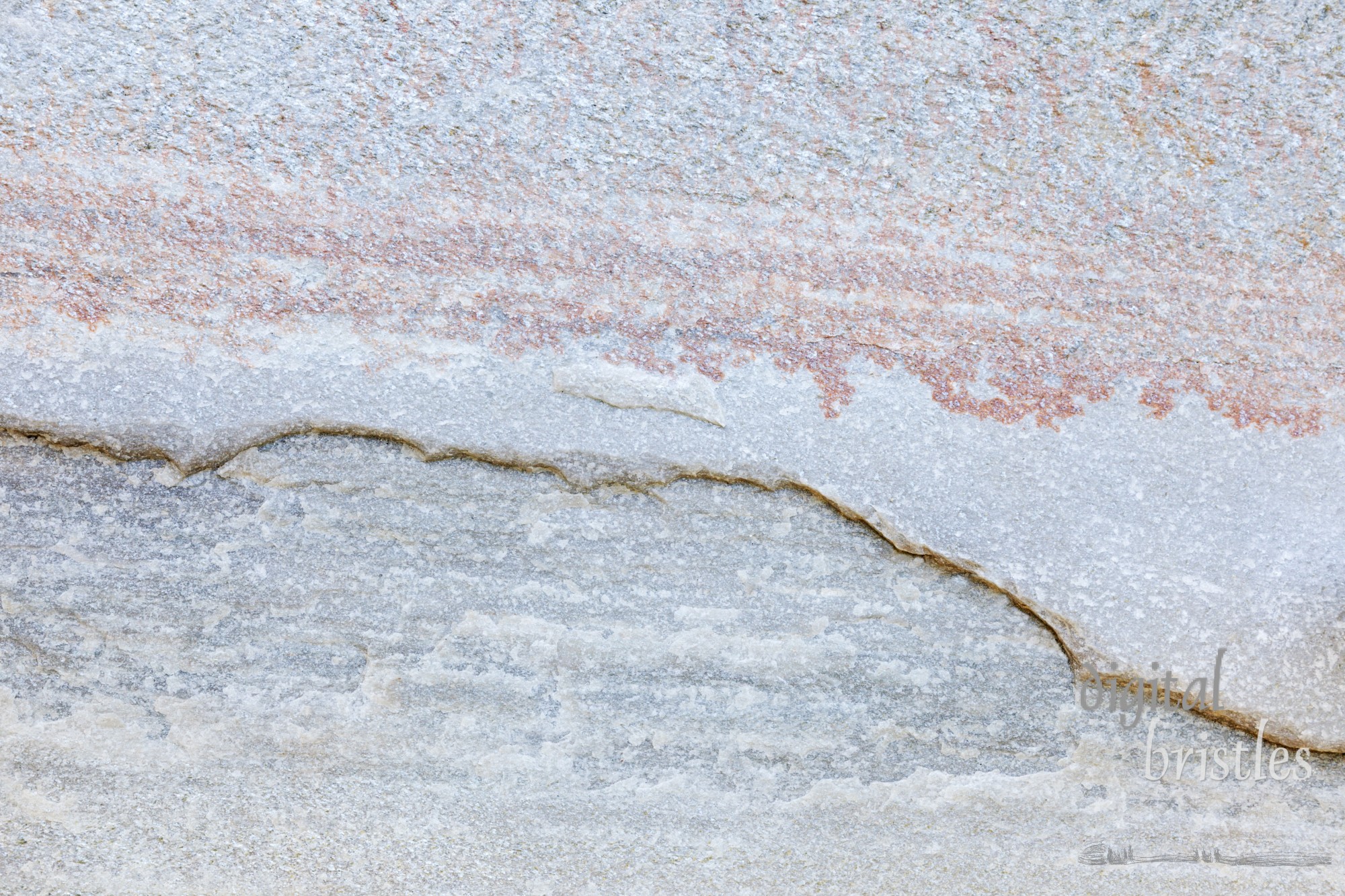 Textured and striated stone paver with jagged ridge line across