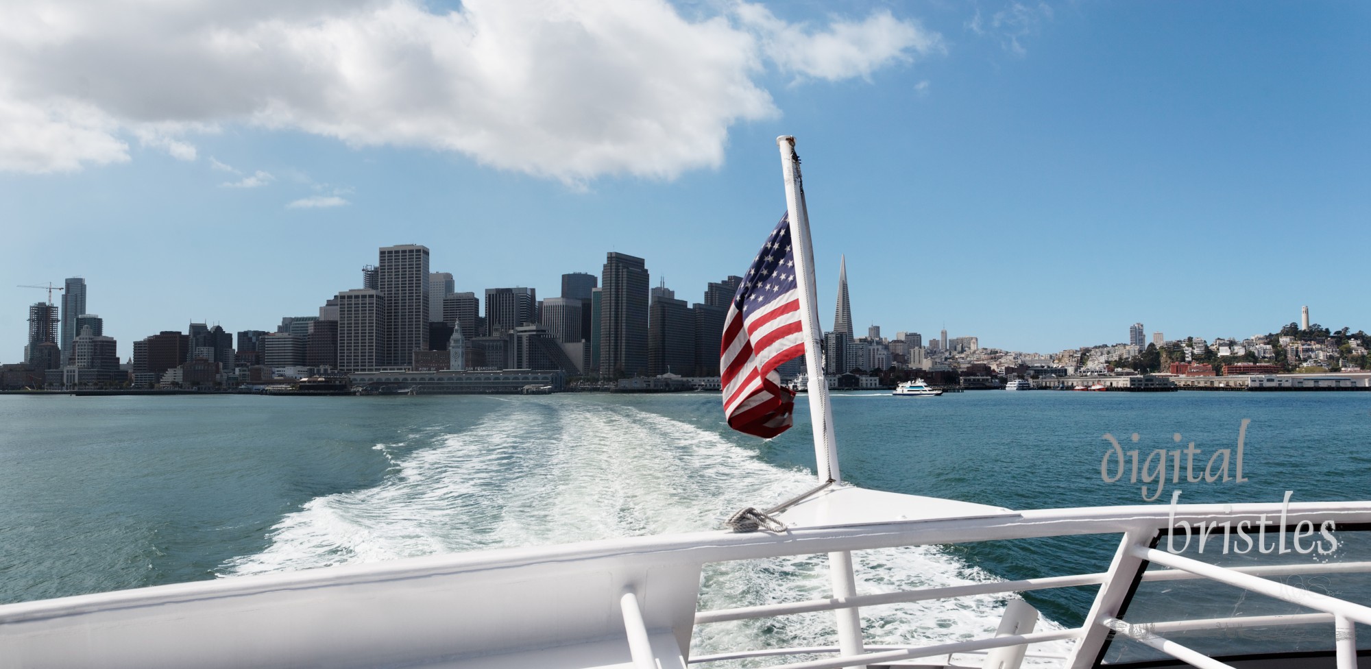 Boat speeds away from San Francisco on a sunny Spring day