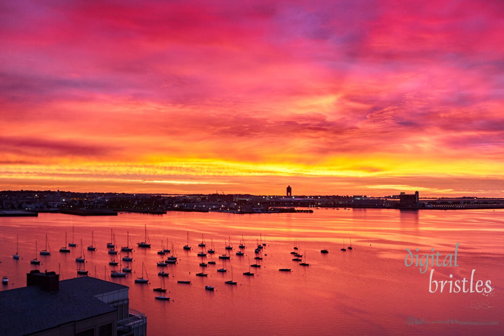 Logan Airport control tower silhouetted against a firey pre-dawn sky, Boston Harbor