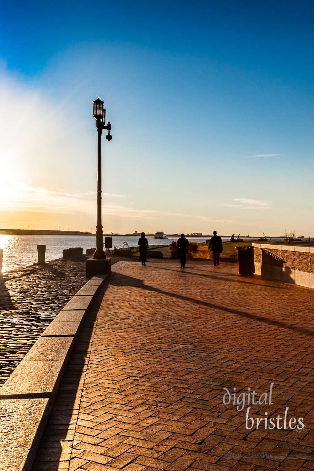 Morning sun on Boston's Harborwalk which stretches over 30 miles around the waterfront and downtown, used by tourists and commuters