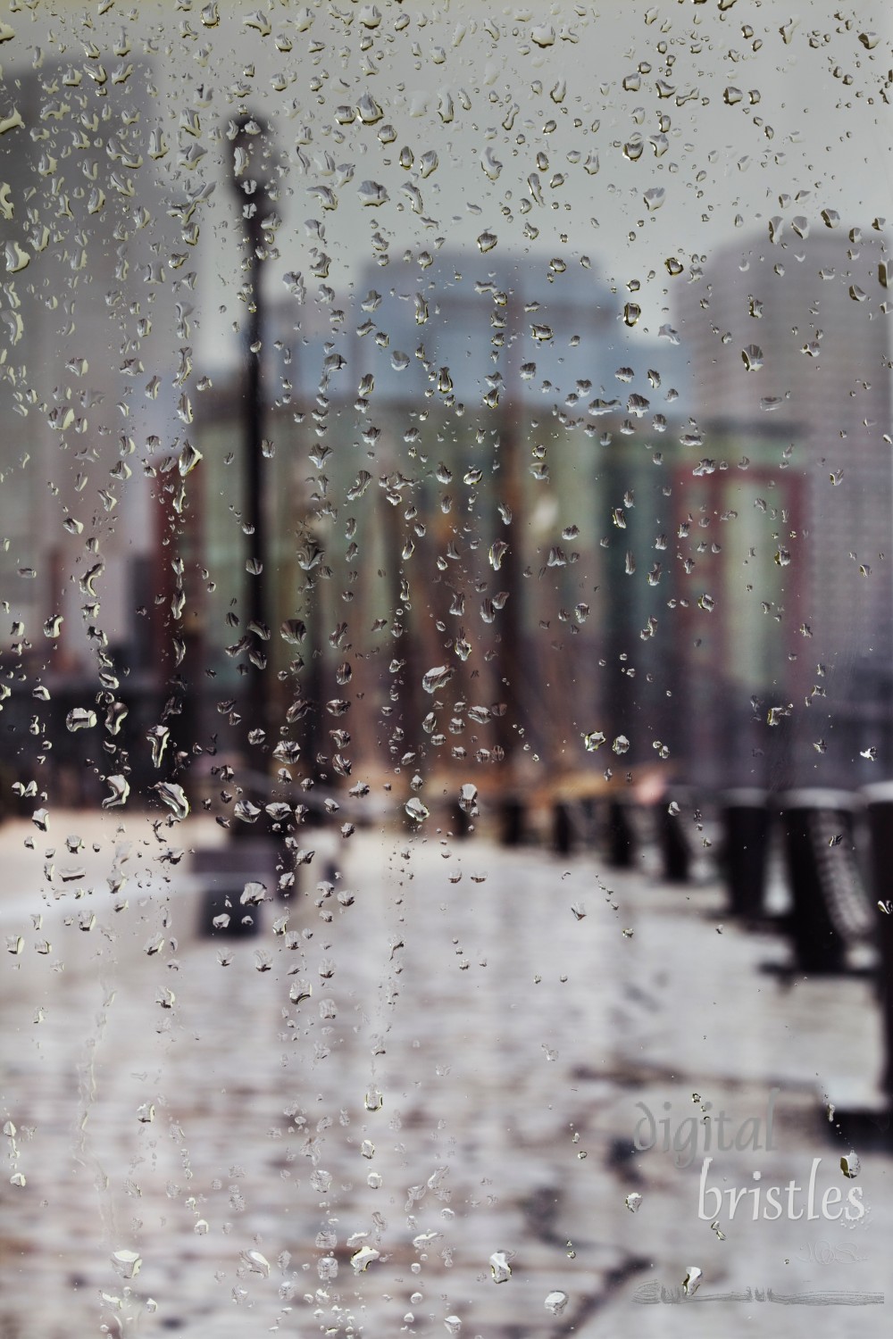 Raindrops on a window looking at Boston's waterfront