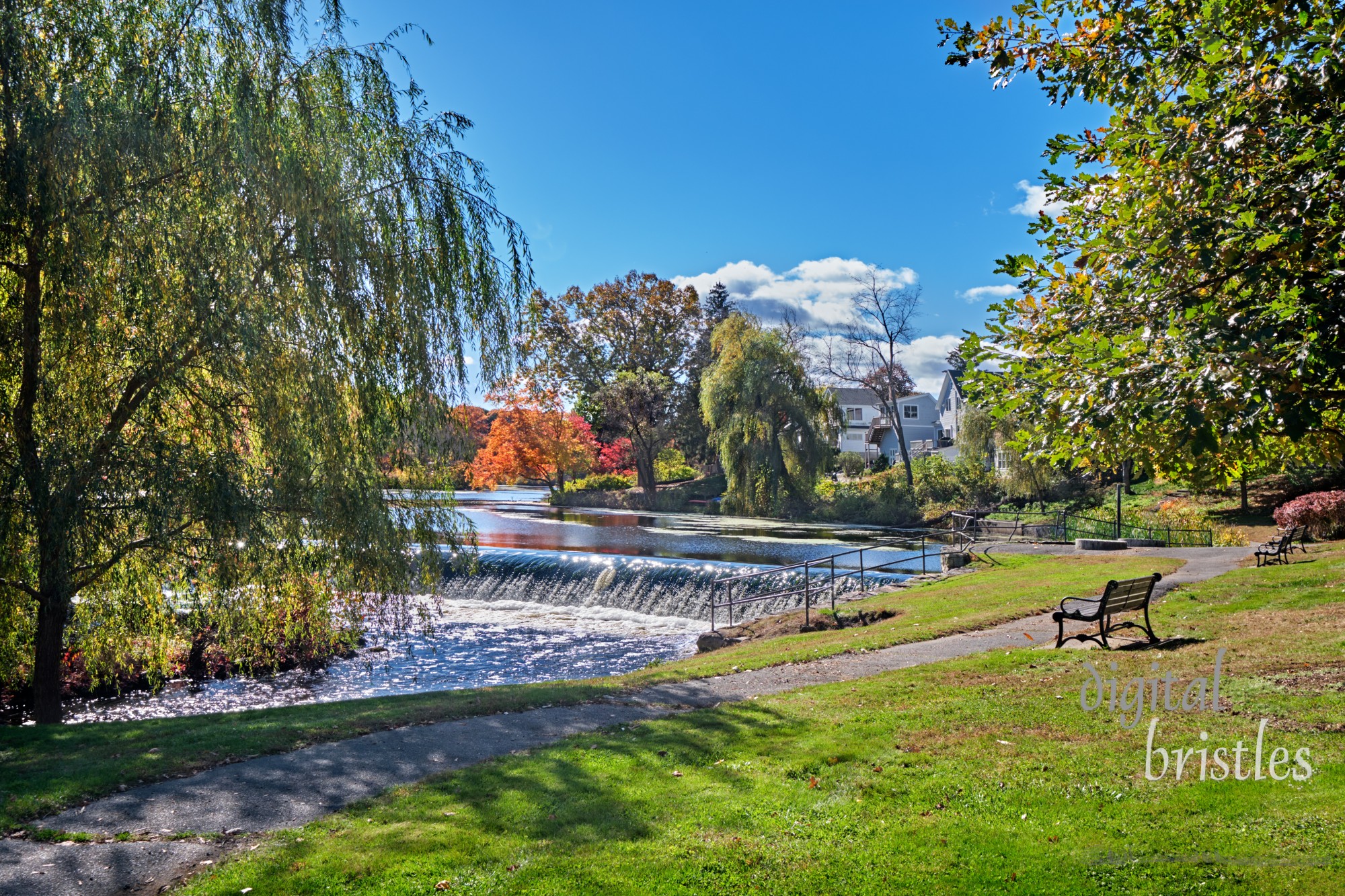 Benches overlooking the Charles River on a sunny Autumn morning in South Natick Dam Park