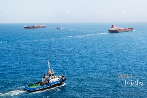 Harbor pilots and tankers entering and leaving busy Caribbean port (Curacao)