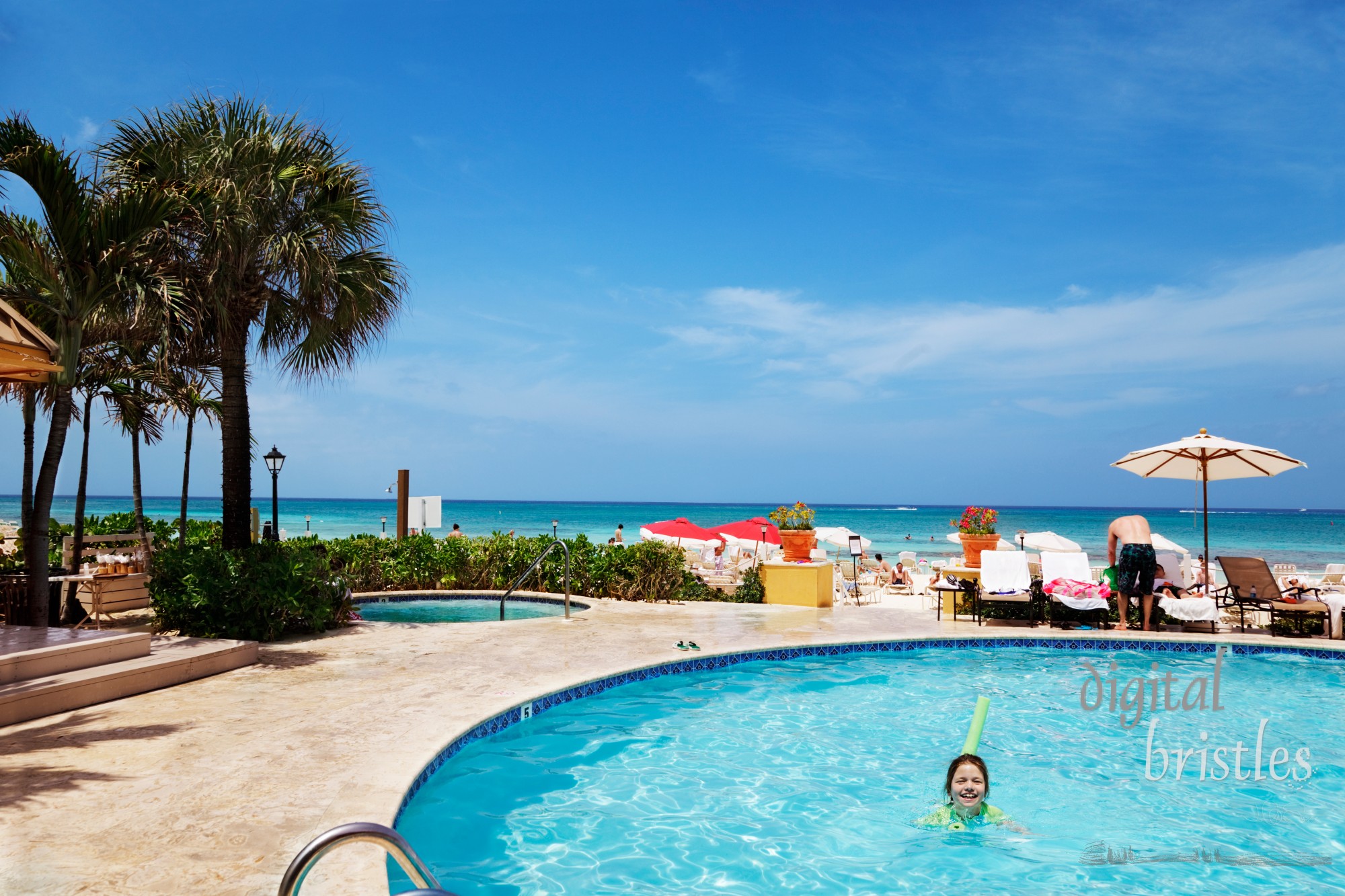 Young girl laughing as she enjoys the pool and Caribbean sunshine