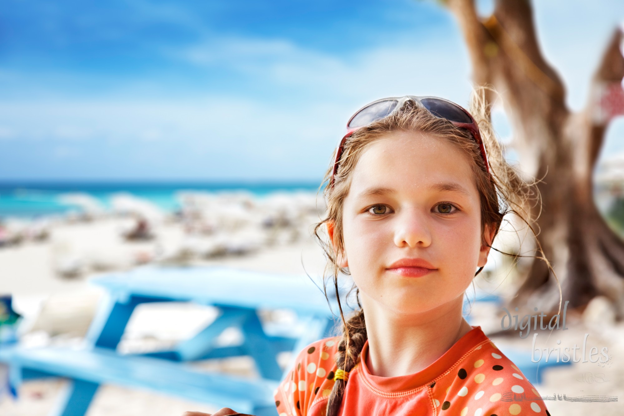 Young girl in the shade on a day at the beach