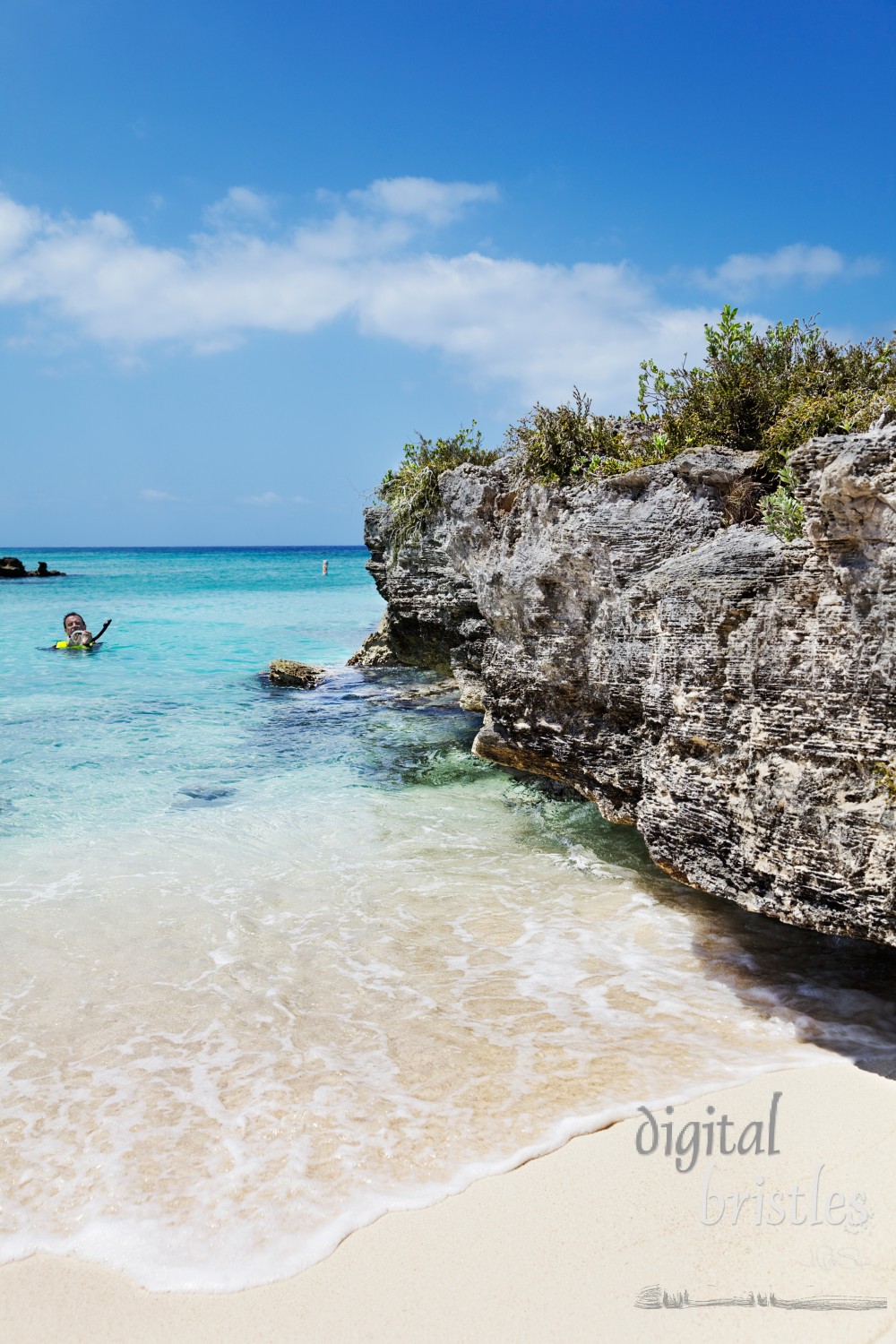 Man adjusts mask before heading out to snorkel off Smith Cove, Grand Cayman