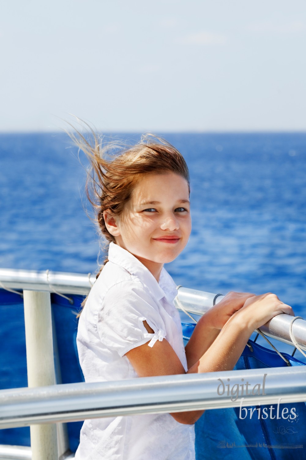 Young girl looks out from a boat rail