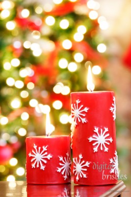 Christmas candles against blurred holiday lights background