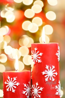 Christmas candles against blurred holiday lights background