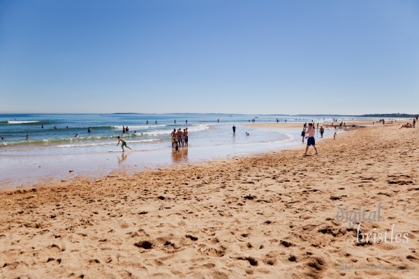 Beachgoers enjoying a sunny summer afternoon at the beach in the 130 year old town of Ocean Park, Maine. The seven mile long sandy beach draws many families to its quiet, unspoiled location and gentle surf.
