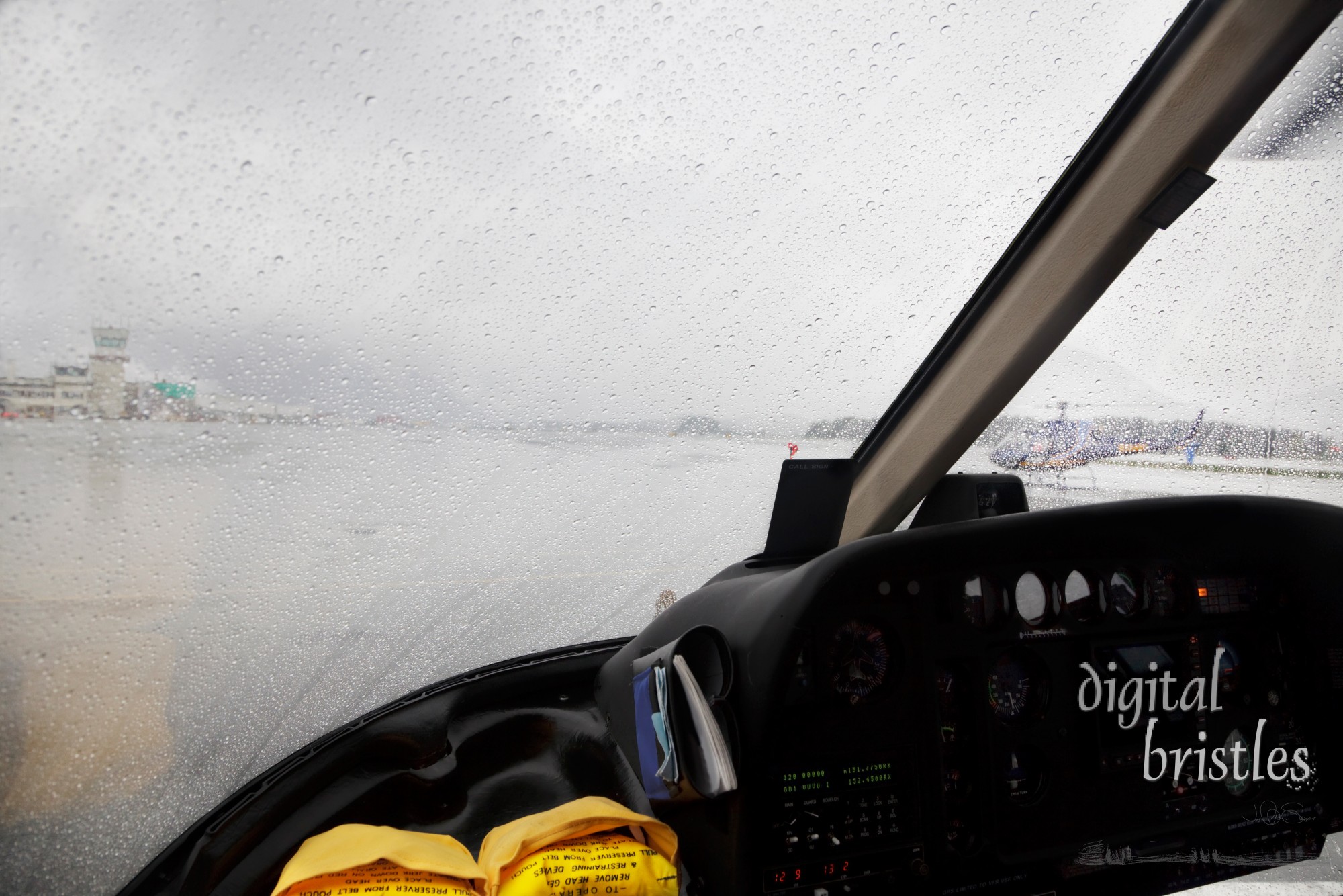 Helicopter cockpit preparing for rainy takeoff