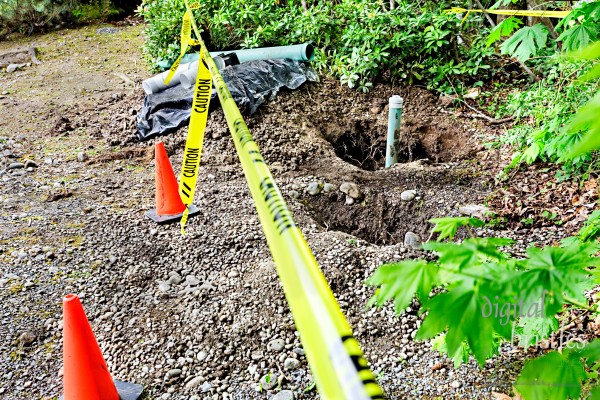 Holes for groundwater drainage pipes, cordon tape and cones for safety