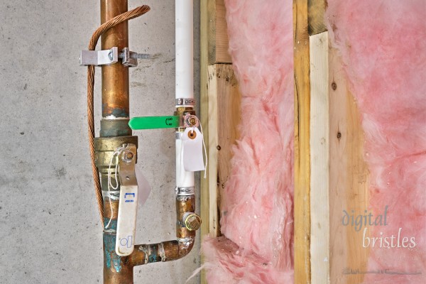 Copper water pipes with shut-off valves, twisted copper wire and grounding clamp