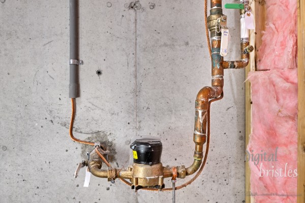 Home's main water line, meter, shutoff valves and copper grounding wire with clamp