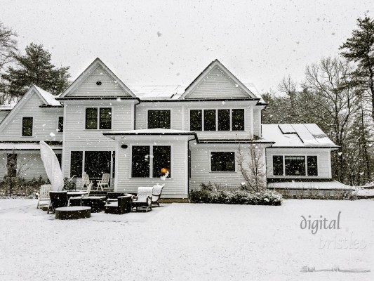 Rooftop solar panels coated in snow in a late Autumn snow storm