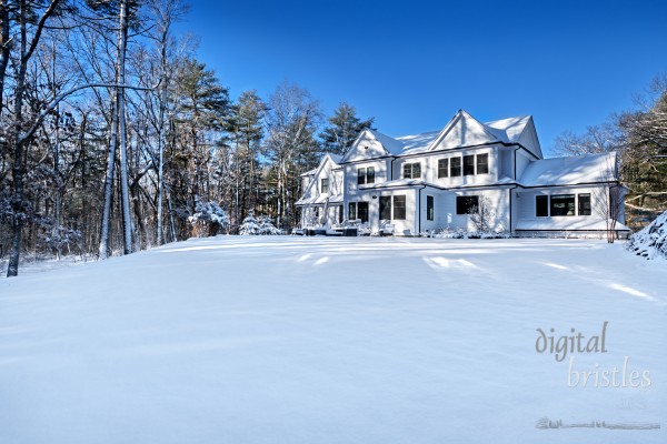 Suburban home in the winter sunshine on a snowy morning