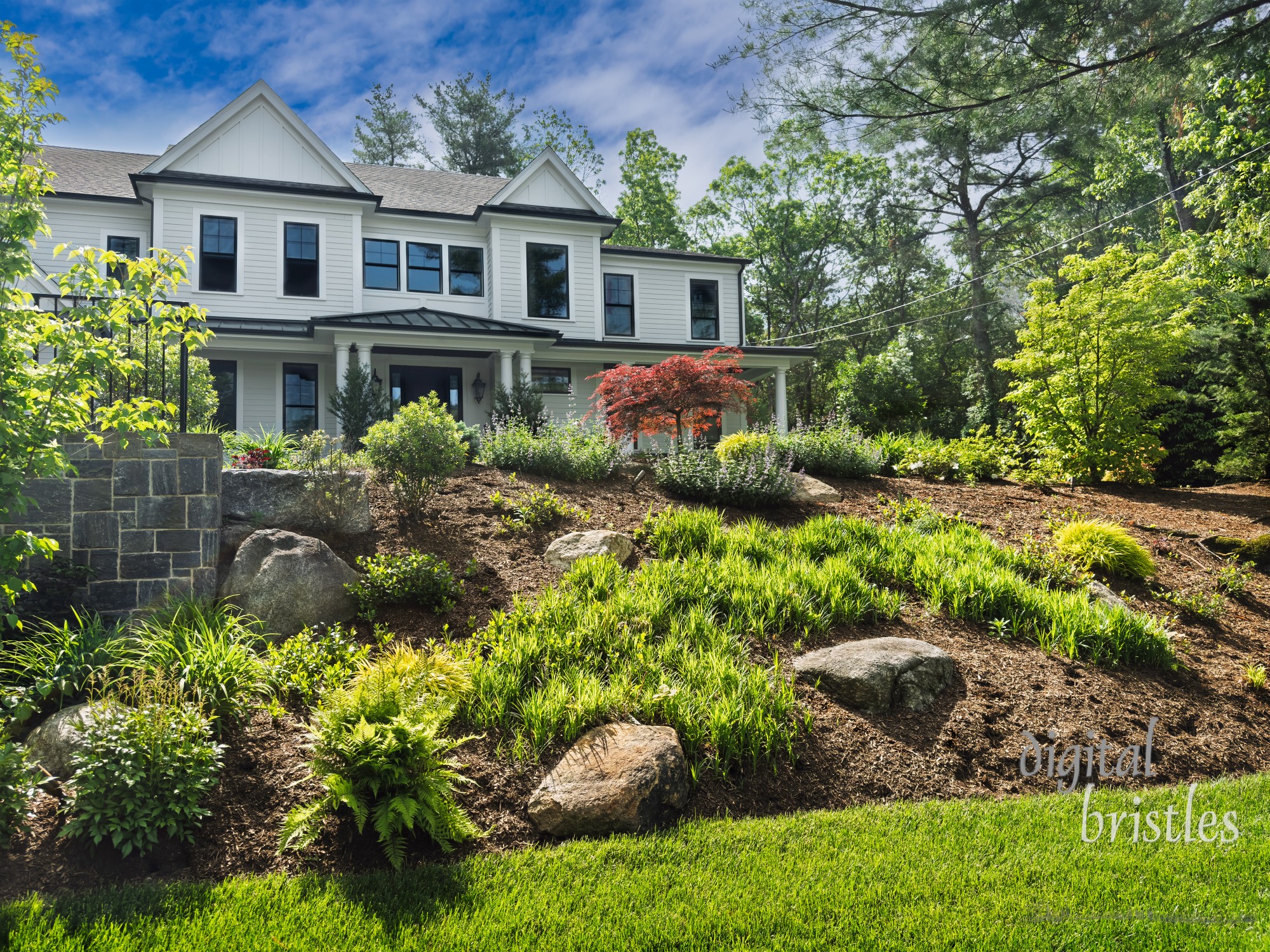Freshly mulched and weedied front flower beds on a Spring day