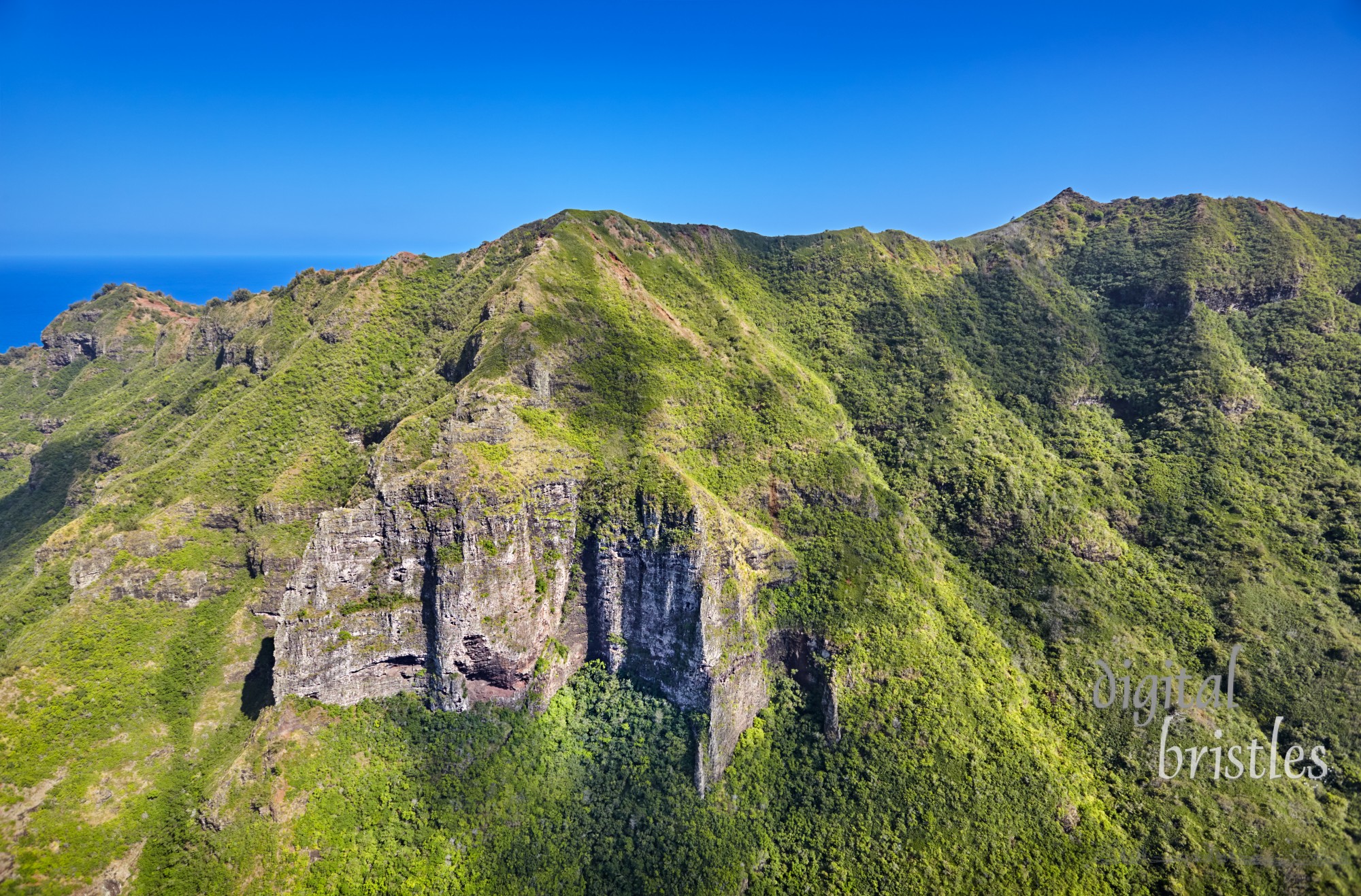 Lush ridges and steep cliffs behind Kipu Kai Beach, Kauai, Hawaii