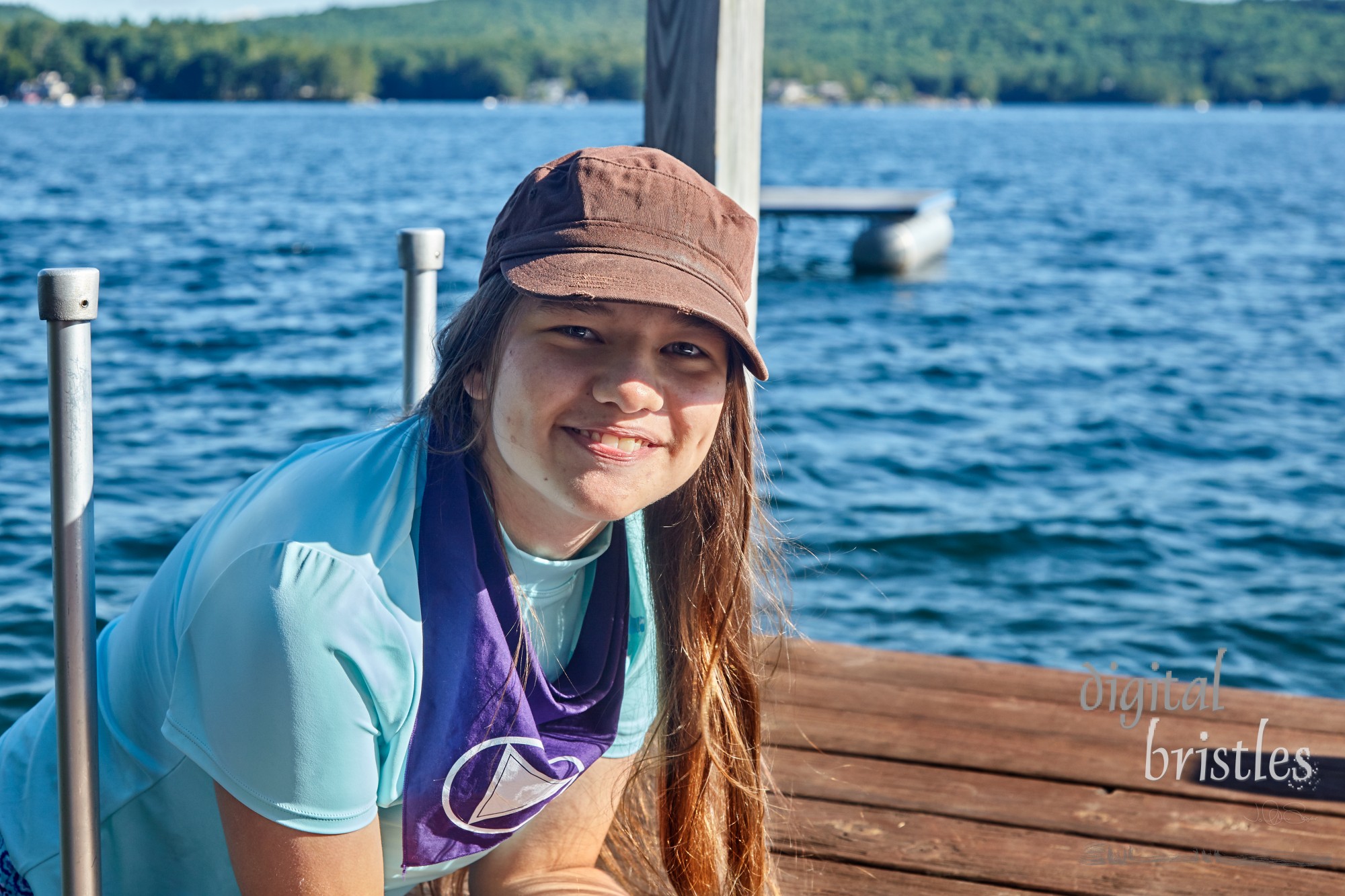 Teenager slowly climbing into a cool lake for a morning swim