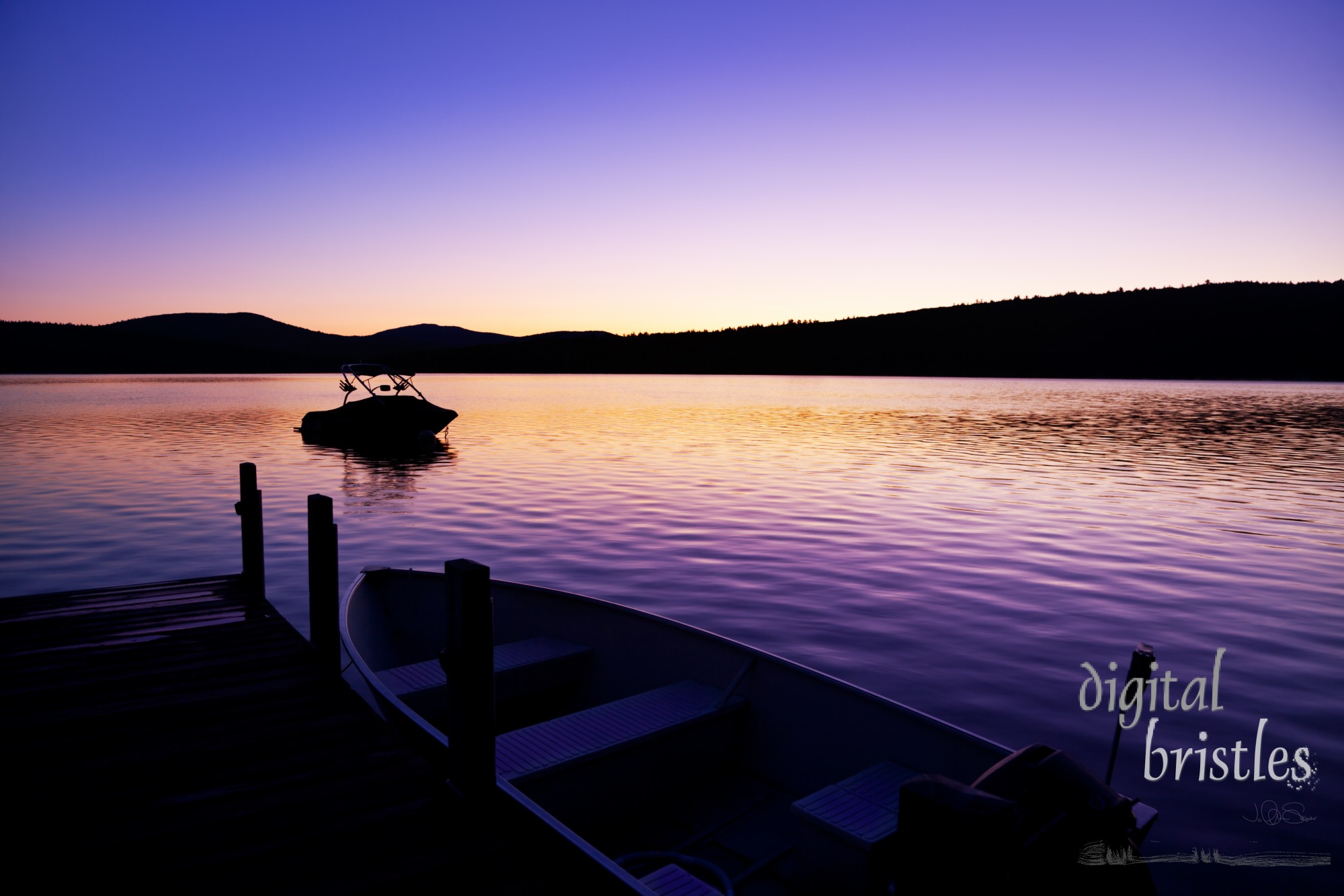 Vivid pre-sunrise colors over a New Hampshire lake on a summer morning