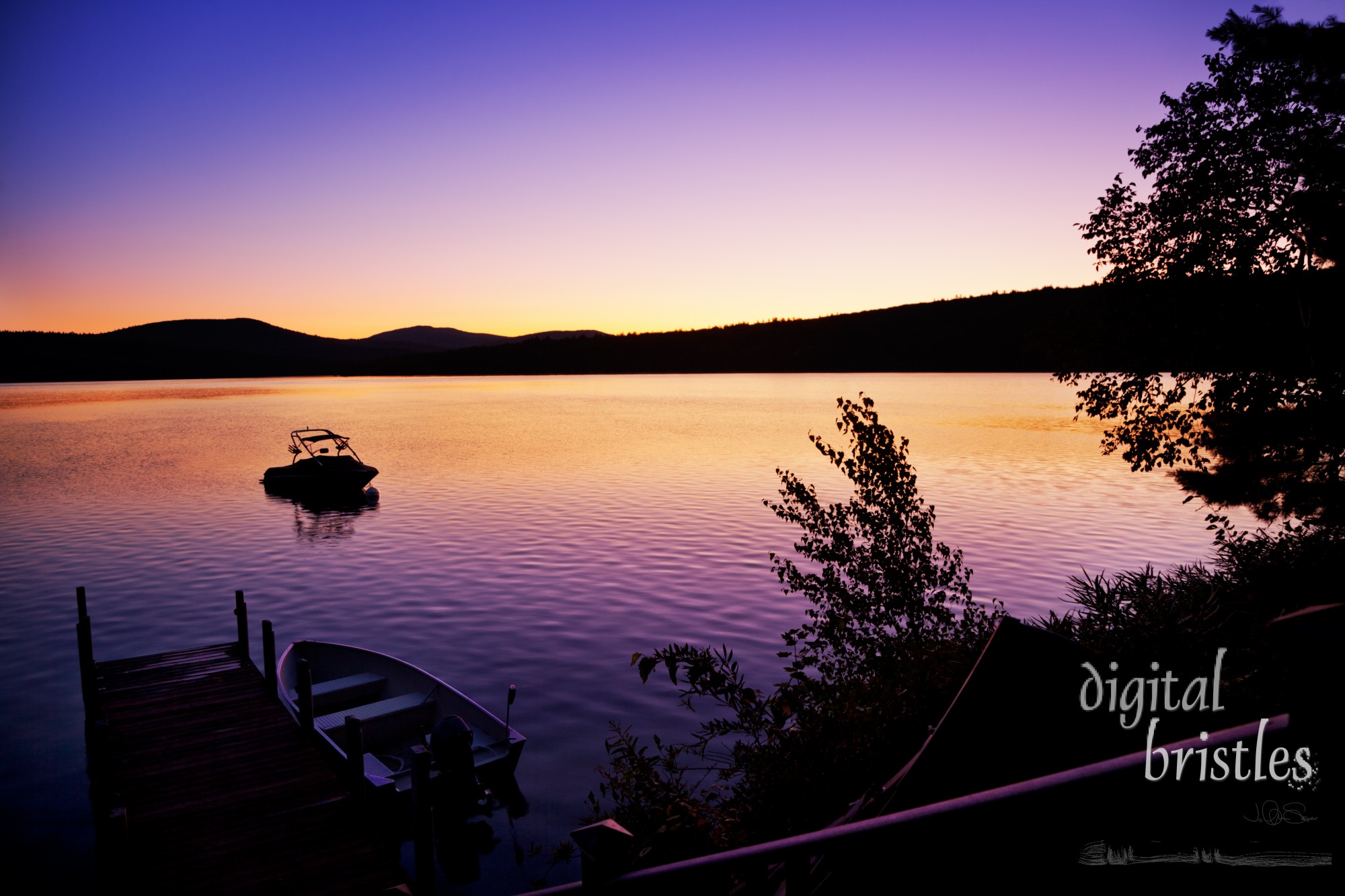 Vivid pre-sunrise colors over  New Hampshire dock and lake on a summer morning