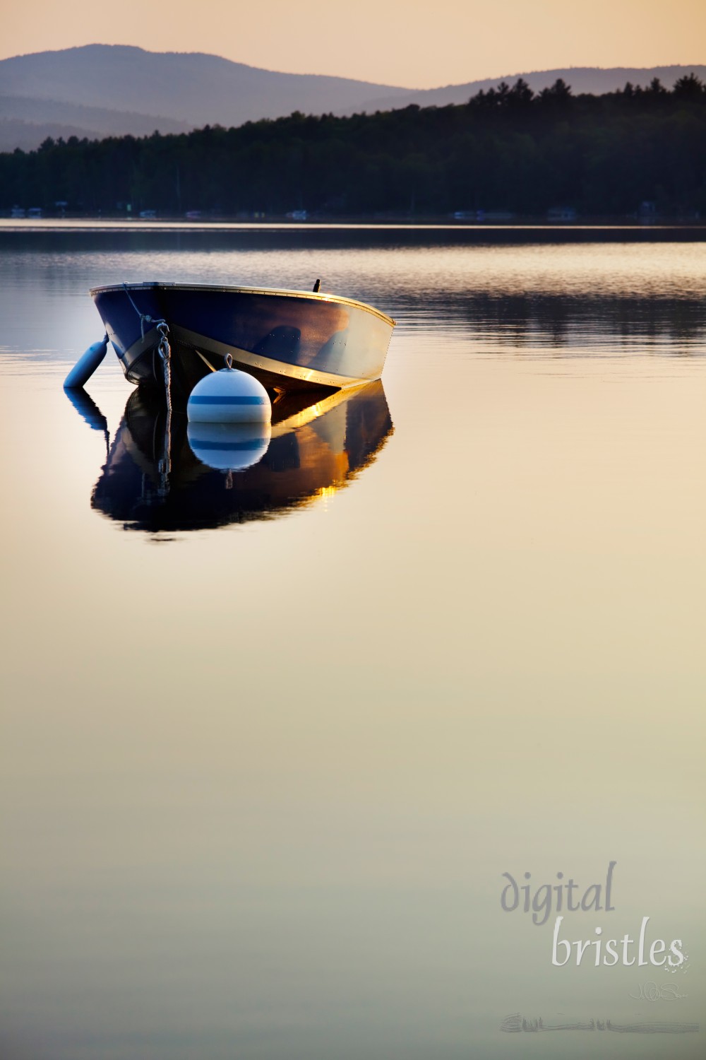 Small boat moored on a still dawn lake