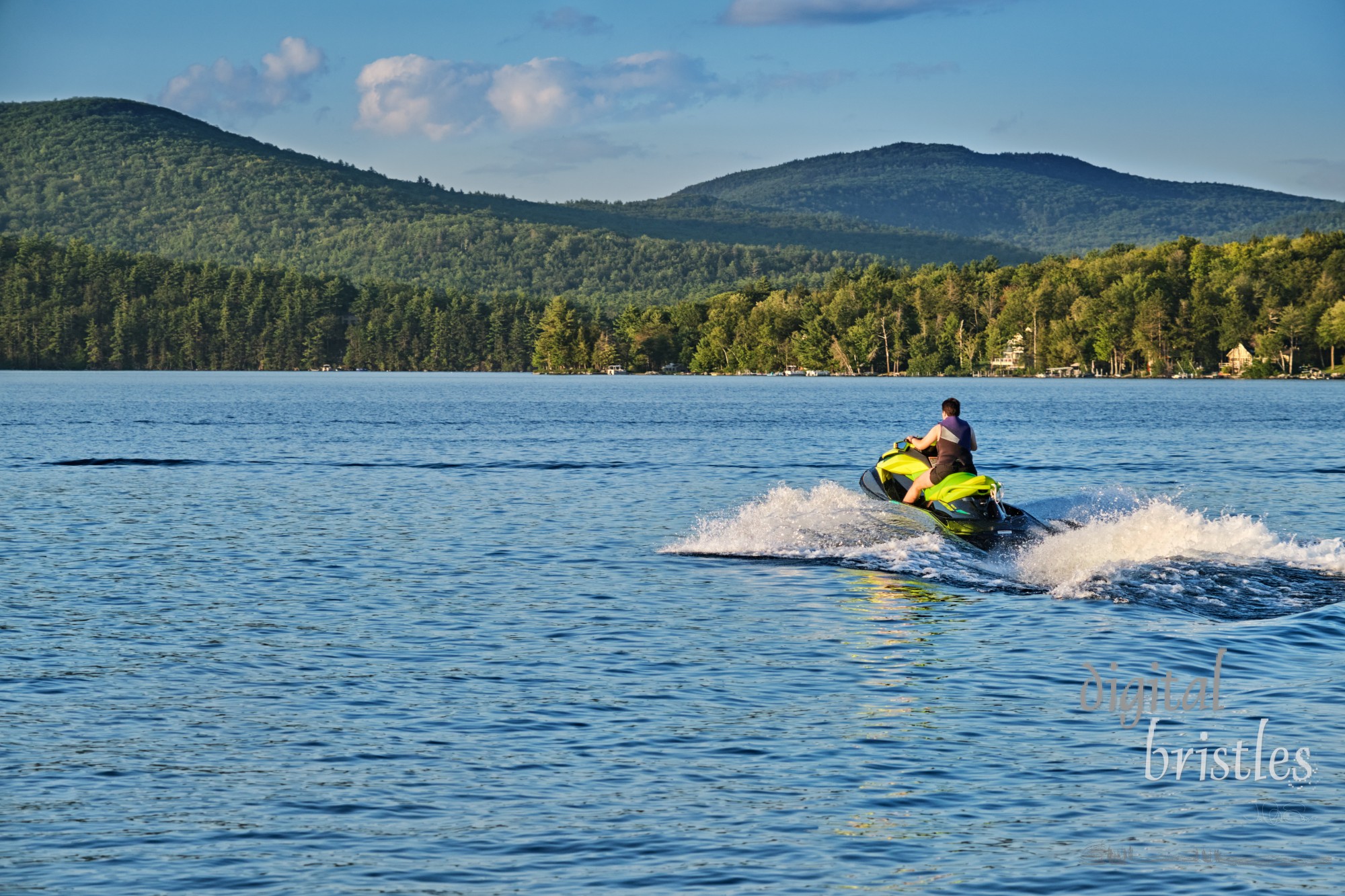 Late afternoon Summer sun lights the wake on the last ride of the day across the lake