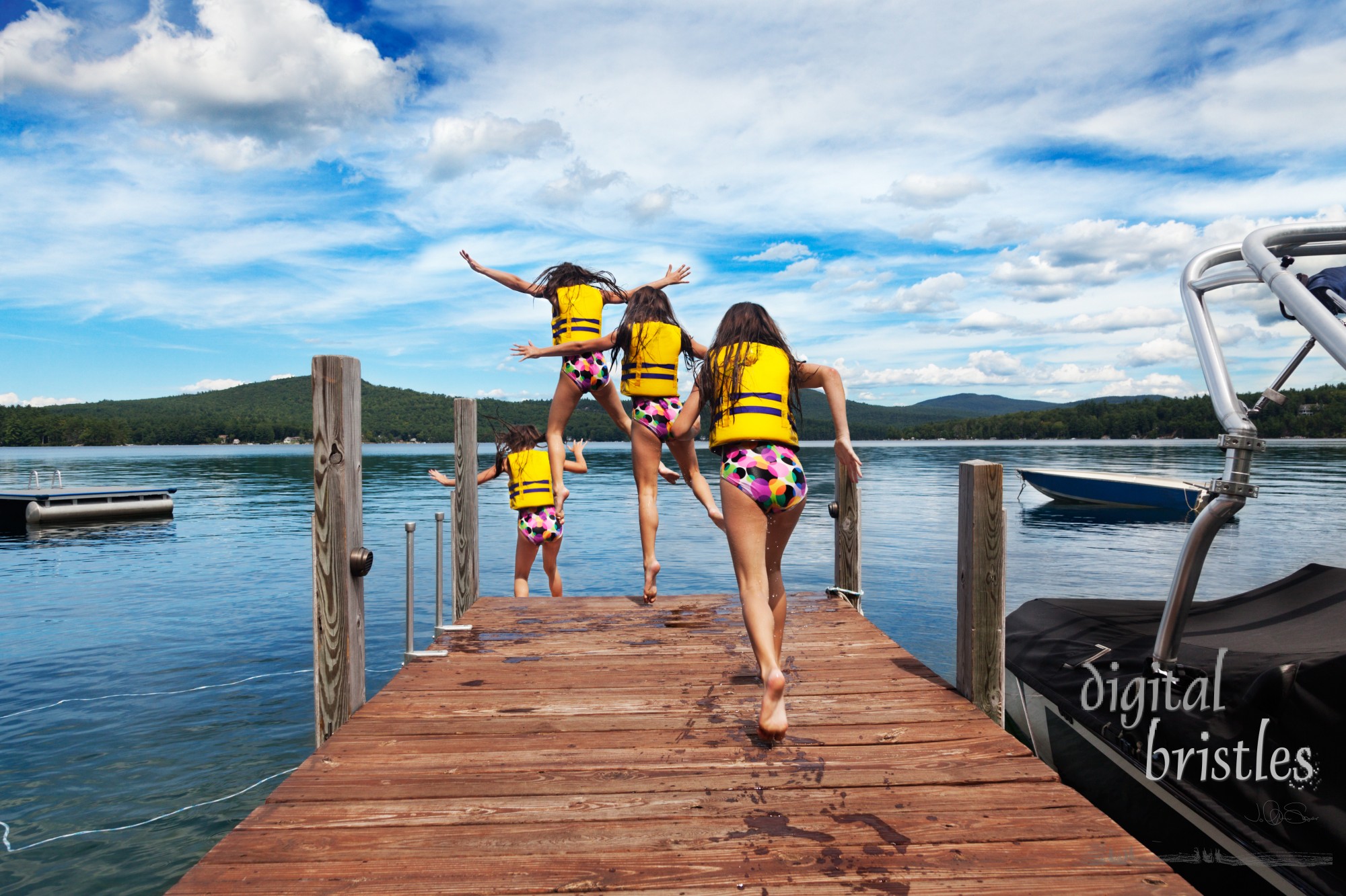 Young girl runs down the dock to jump to a warm summer lake