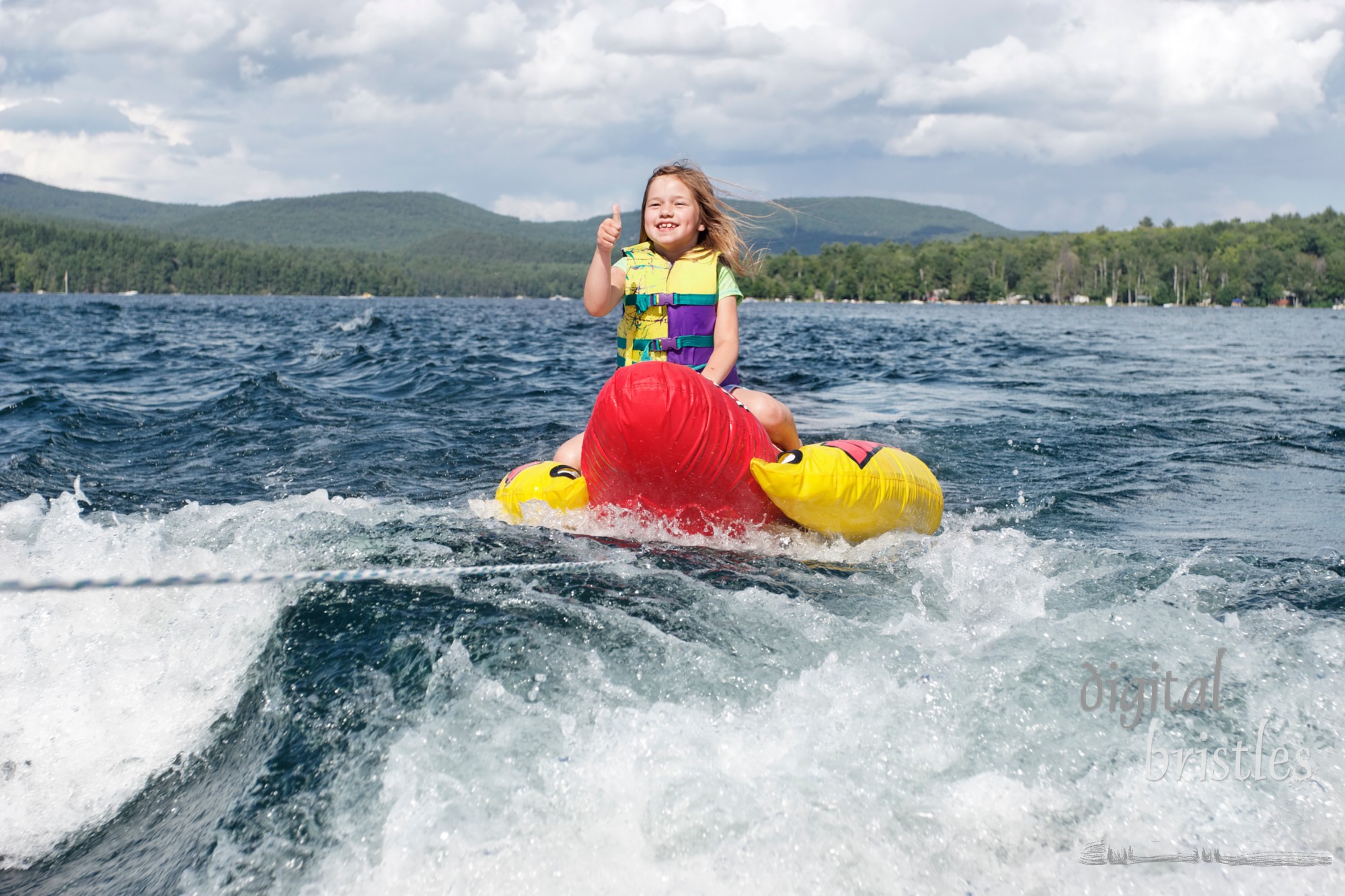 Young girl gives the thumbs up sign as she wants to go faster