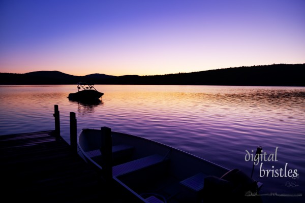Vivid pre-sunrise colors over a New Hampshire lake on a summer morning