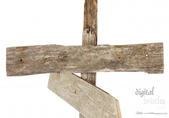 Rough hewn wood sign nailed to a post