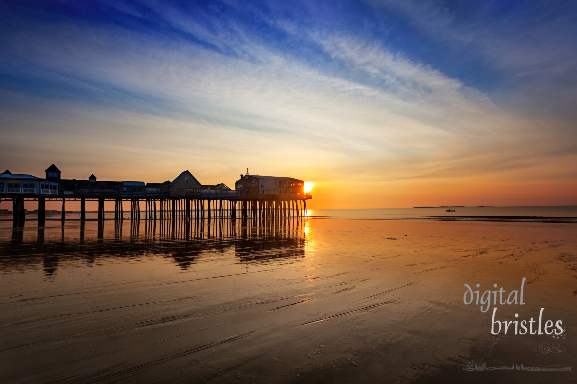 Sun rises over the wet sands and pier, Old Orchard Beach Maine