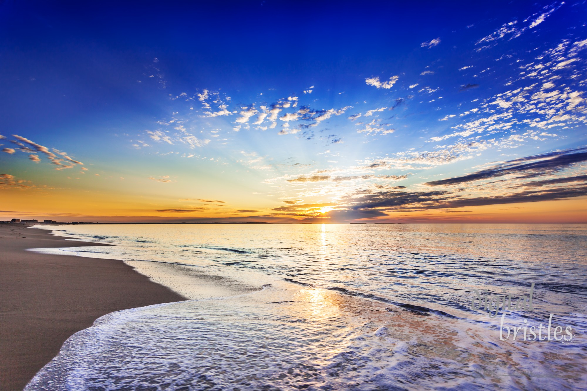 Sunrise over gently lapping waves in Ocean Park on a warm August morning