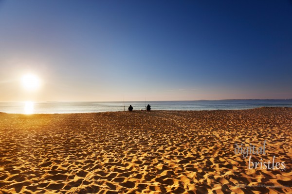 Sun comes over the horizon on a Maine beach in summer