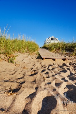 The end of a boardwalk onto a Maine beach, early morning