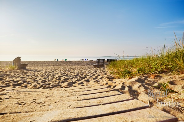 Early morning at a Maine beach in summer, chairs placed to reserve a good spot