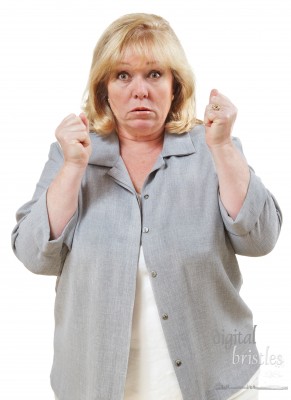 Angry mature woman, fists clenched and eyes bulging