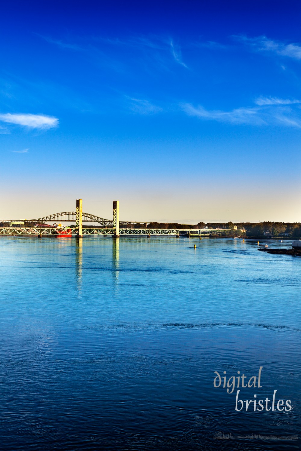 Morning sun hits the Piscataqua River and Sarah M. Long Bridges, connecting Portsmouth, New Hampshire and Maine