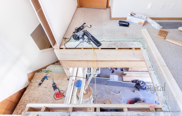 Removing heating duct and supporting beam to make way for new stairs. Gas pipes remain