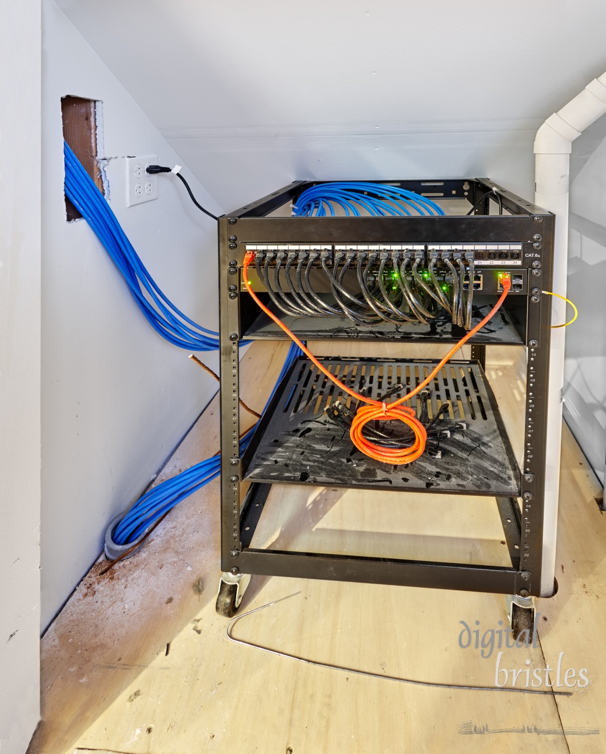 Rack mounted switch connected to network cables routed throughout both levels of the house. Small closet under the stairs.